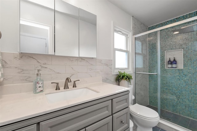 102 Spruce Ln, Valley Stream, NY 11581 - full bathroom with vanity, toilet, a shower stall, tile walls, and tasteful backsplash