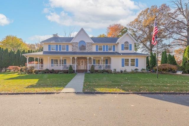view of front of house featuring a chimney, a porch, and a front yard
