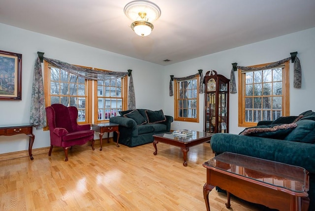 living area with light wood-type flooring and visible vents