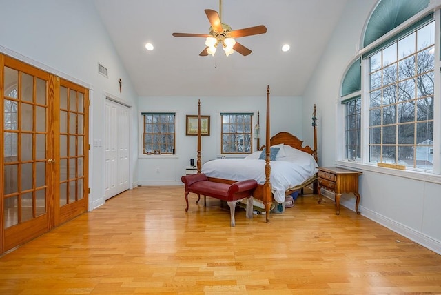 bedroom featuring baseboards, french doors, and light wood finished floors