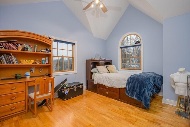 bedroom with baseboards, light wood-style flooring, and lofted ceiling