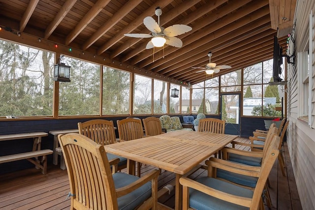 sunroom with ceiling fan and outdoor dining space