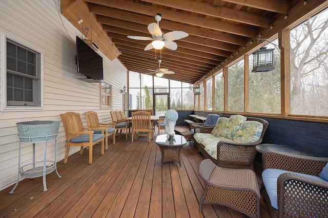 sunroom with an outdoor living space, a ceiling fan, and beam ceiling