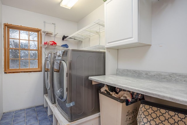 washroom with cabinet space and washer and clothes dryer