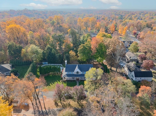 bird's eye view with a wooded view