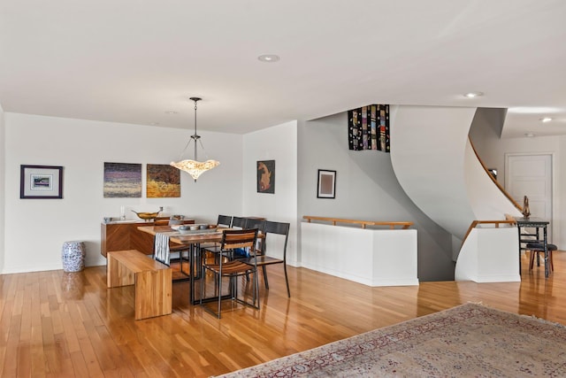 dining space featuring recessed lighting, baseboards, and wood finished floors