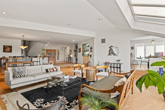 living room with recessed lighting and wood finished floors