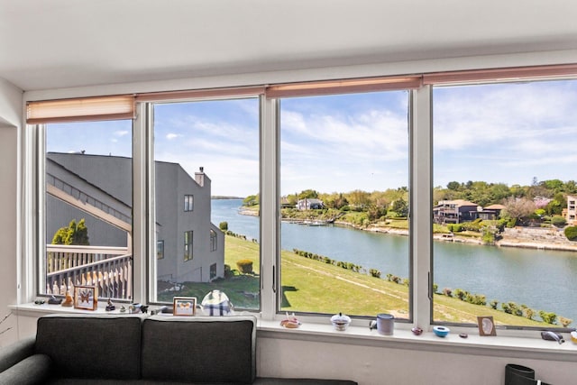sunroom / solarium featuring a water view