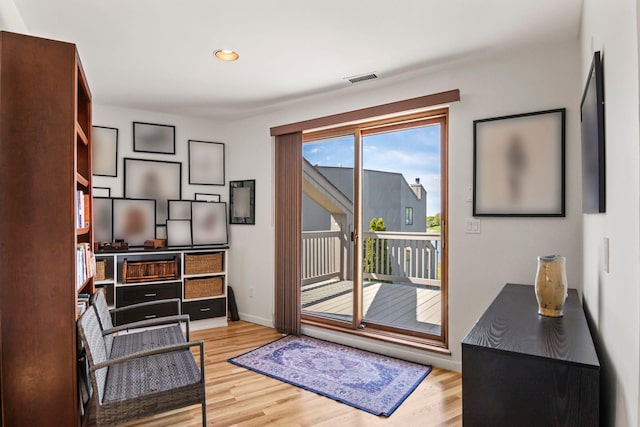 doorway to outside featuring baseboards, recessed lighting, wood finished floors, and visible vents