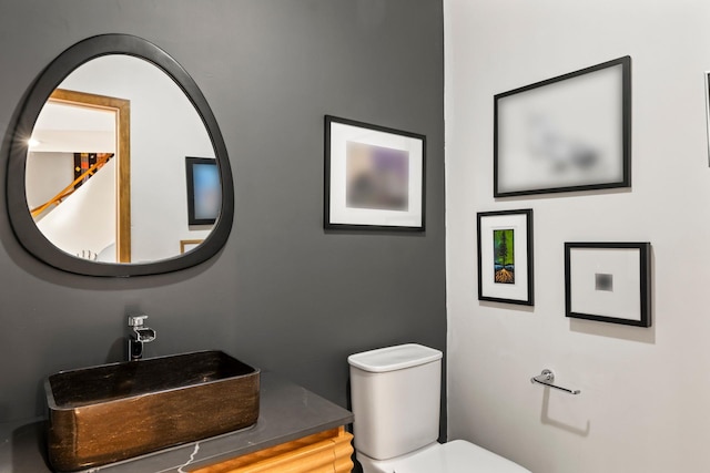 bathroom with toilet and a sink