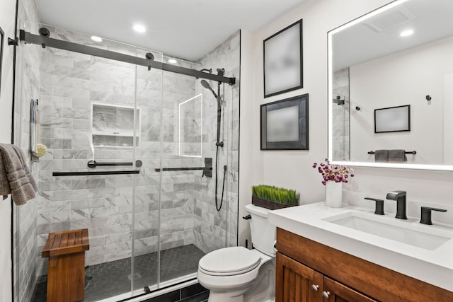 full bathroom with toilet, recessed lighting, a shower stall, and vanity