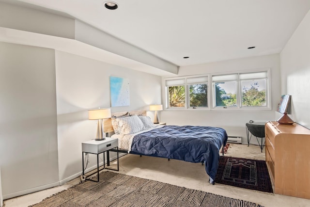 bedroom featuring a baseboard heating unit and recessed lighting