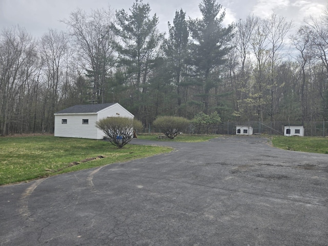 view of road with driveway and a wooded view