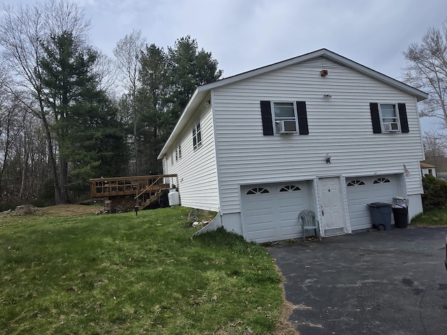 exterior space with driveway, a deck, stairway, a yard, and a garage