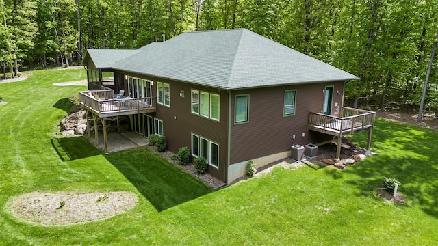 240 Brady Rd, Warwick, NY 10990 - rear view of property with a deck, a shingled roof, a lawn, a view of trees, and a sunroom