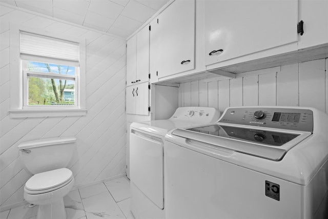 clothes washing area featuring marble finish floor, laundry area, and separate washer and dryer
