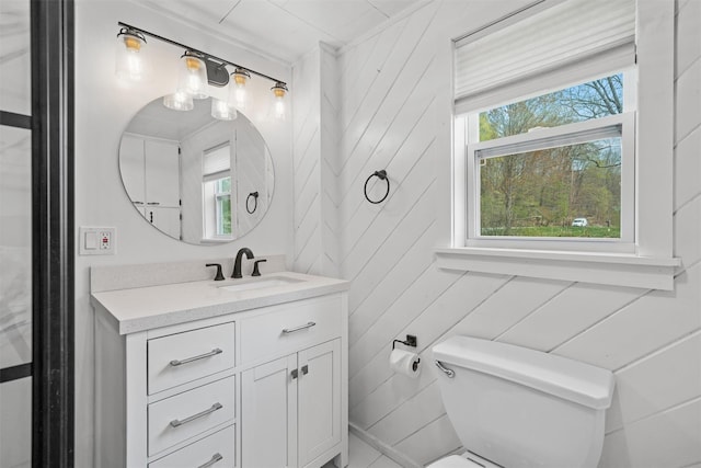 half bathroom featuring vanity and toilet