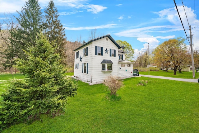 view of side of property featuring a yard