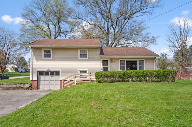 tri-level home featuring asphalt driveway and an attached garage