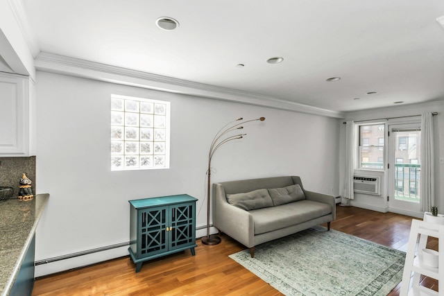 living area featuring ornamental molding, a baseboard radiator, light wood finished floors, and recessed lighting