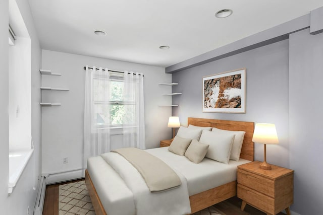 bedroom with wood finished floors, a baseboard radiator, and recessed lighting