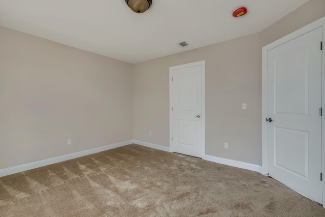 unfurnished bedroom with visible vents, baseboards, and carpet floors