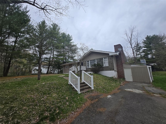 view of side of property with an outdoor structure, stone siding, a chimney, a storage shed, and a yard