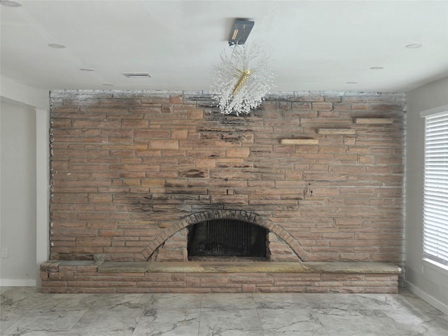 details featuring baseboards, visible vents, and a fireplace