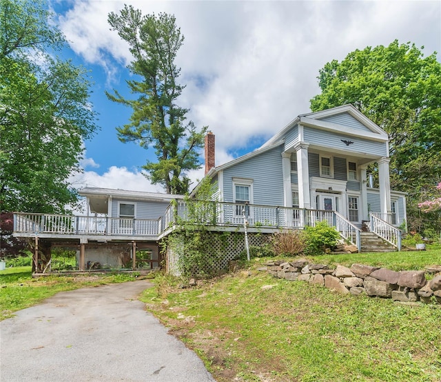 1603 Goshen Tpke, Middletown, NY 10941 - neoclassical / greek revival house with driveway, a chimney, a deck, and a front lawn