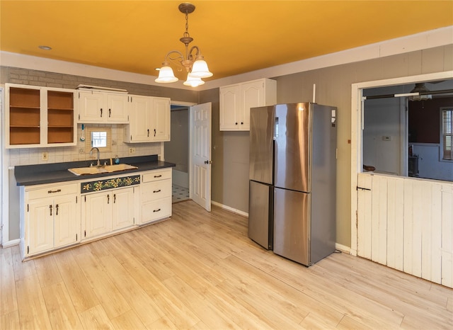 1603 Goshen Tpke, Middletown, NY 10941 - kitchen with freestanding refrigerator, dark countertops, white cabinets, and light wood-style floors