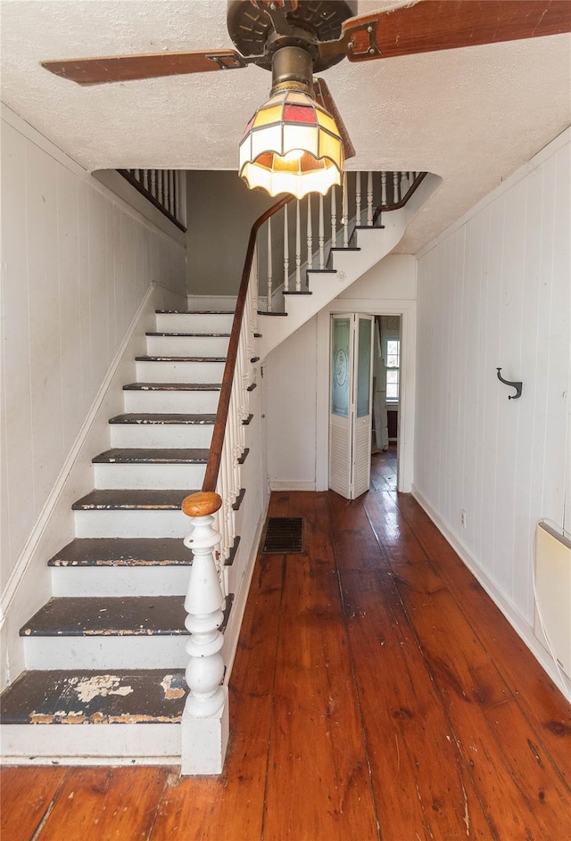 1603 Goshen Tpke, Middletown, NY 10941 - stairs with hardwood / wood-style floors, wooden walls, baseboards, and a textured ceiling