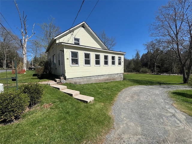 view of side of property featuring a yard