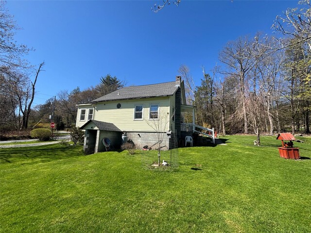view of property exterior with a chimney, a shingled roof, and a yard