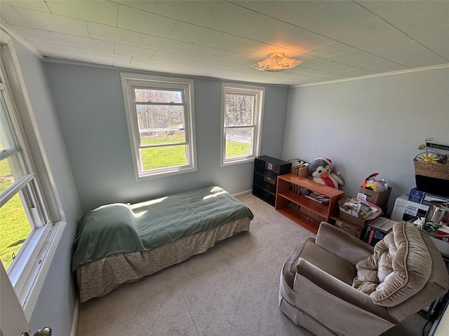 bedroom featuring ornamental molding, carpet floors, and baseboards