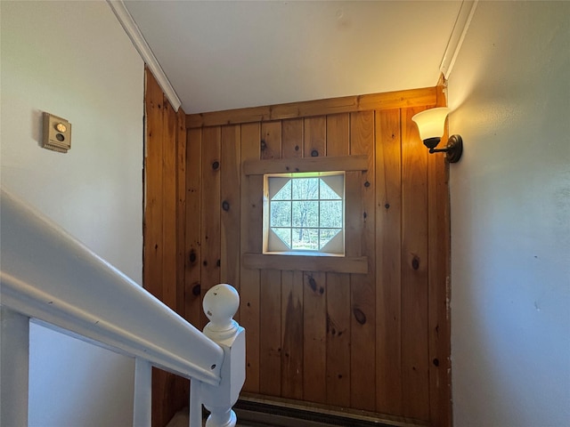 doorway to outside featuring wood walls
