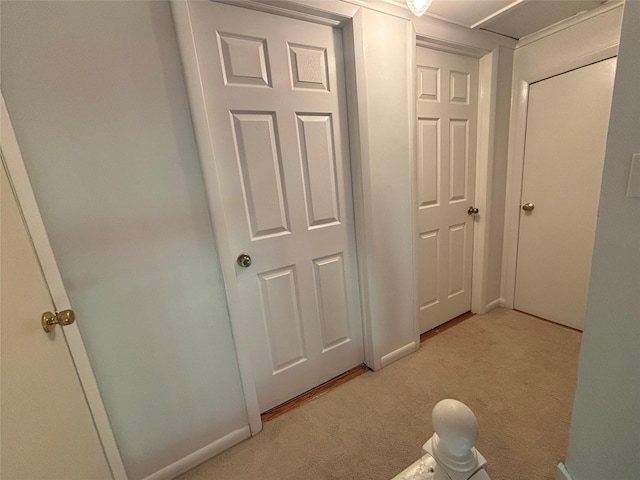 hall with light carpet and baseboards