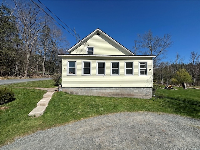 view of side of home featuring a lawn