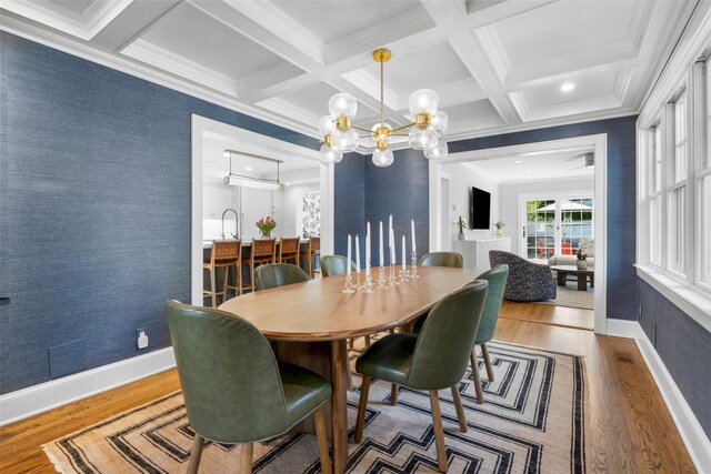 dining space with baseboards, wood finished floors, a notable chandelier, and beamed ceiling