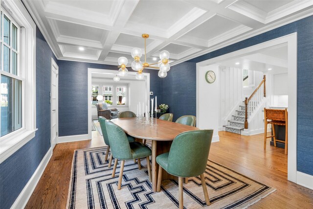 dining space with stairs, beamed ceiling, wood finished floors, and coffered ceiling