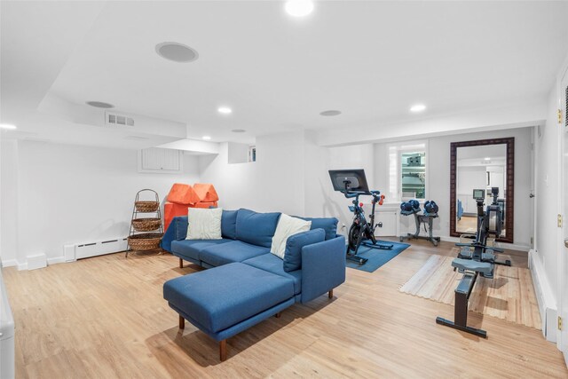 workout area featuring baseboard heating, light wood-style flooring, recessed lighting, baseboards, and visible vents