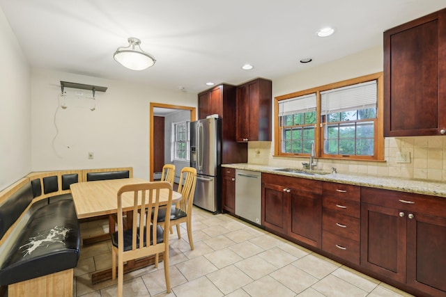 54 Cedar St, Stony Brook, NY 11790 - kitchen with stainless steel appliances, a sink, reddish brown cabinets, backsplash, and recessed lighting