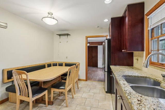 54 Cedar St, Stony Brook, NY 11790 - kitchen featuring a sink, dark brown cabinets, baseboards, freestanding refrigerator, and recessed lighting
