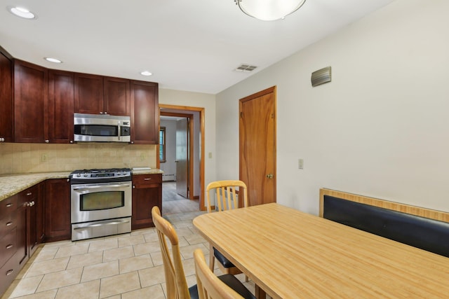 54 Cedar St, Stony Brook, NY 11790 - kitchen featuring appliances with stainless steel finishes, tasteful backsplash, recessed lighting, reddish brown cabinets, and light tile patterned floors