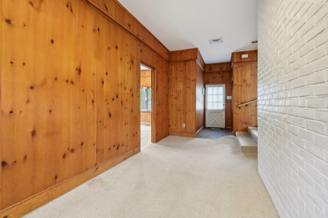 54 Cedar St, Stony Brook, NY 11790 - carpeted empty room featuring wooden walls and baseboards