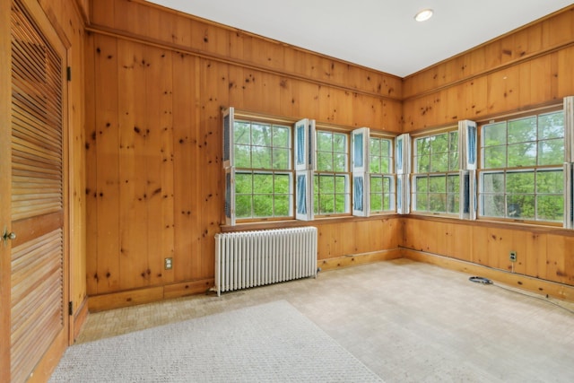 54 Cedar St, Stony Brook, NY 11790 - empty room featuring radiator heating unit, wood walls, baseboards, and recessed lighting