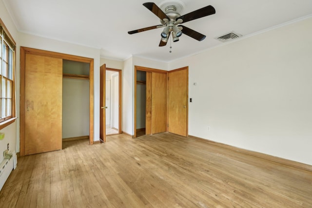 54 Cedar St, Stony Brook, NY 11790 - unfurnished bedroom featuring two closets, light wood-type flooring, baseboards, ornamental molding, and ceiling fan