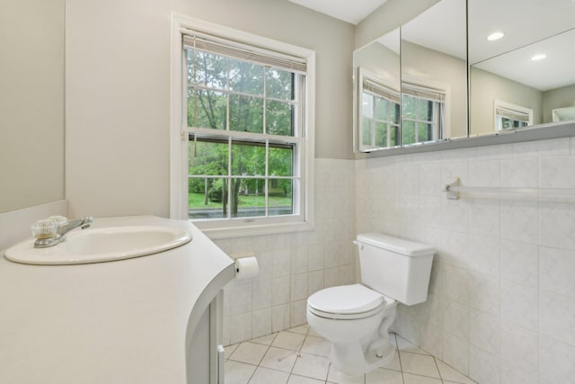 54 Cedar St, Stony Brook, NY 11790 - bathroom featuring tile walls, tile patterned floors, toilet, vanity, and wainscoting
