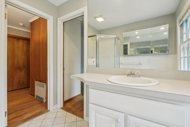 54 Cedar St, Stony Brook, NY 11790 - bathroom with radiator heating unit, tile patterned flooring, vanity, a shower stall, and baseboards