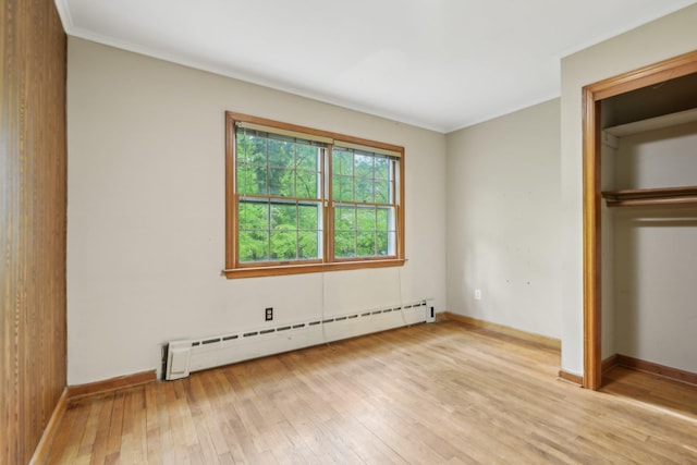 54 Cedar St, Stony Brook, NY 11790 - unfurnished bedroom with baseboard heating, light wood-style flooring, ornamental molding, and baseboards