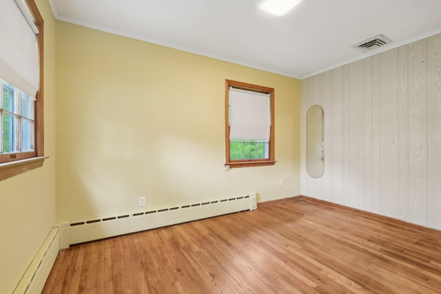 54 Cedar St, Stony Brook, NY 11790 - empty room with a baseboard radiator, wood finished floors, ornamental molding, wood walls, and baseboards